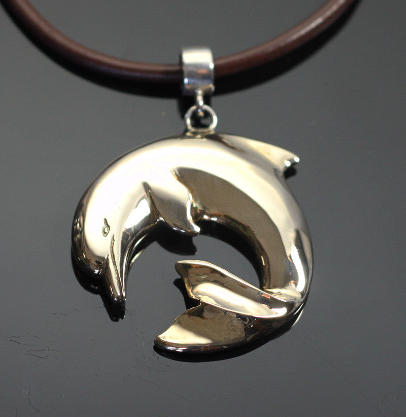 Handcrafted bronze dolphin pendant from a current Southern maker