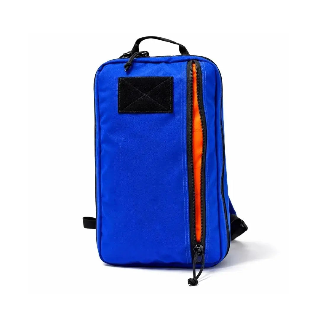 Blue sling backpack with an orange interior and a front zipper.