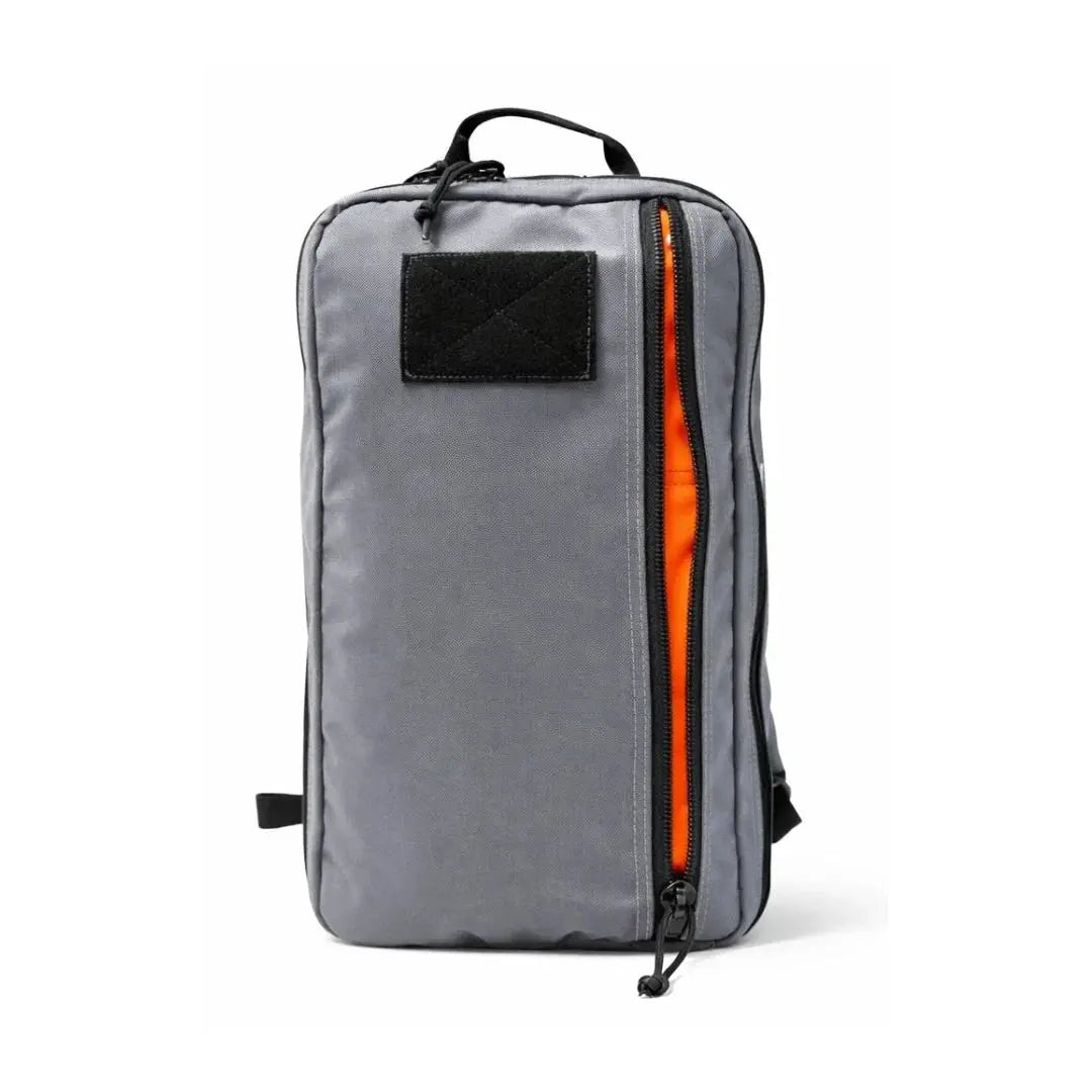 Gray tactical backpack with a bright orange interior and a large front zipper pocket.