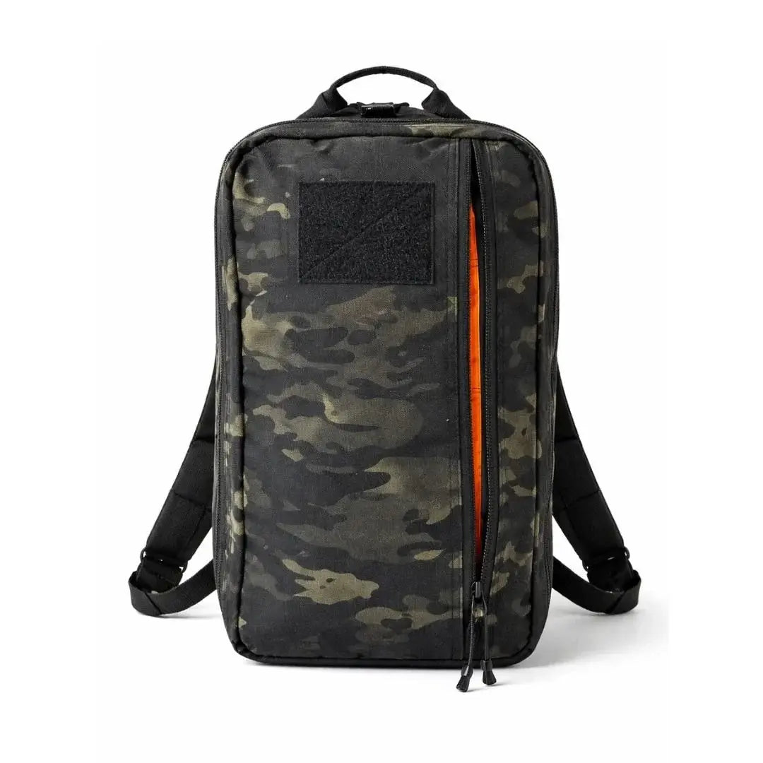 Black and green camouflage backpack with orange zipper detail and a black patch area.