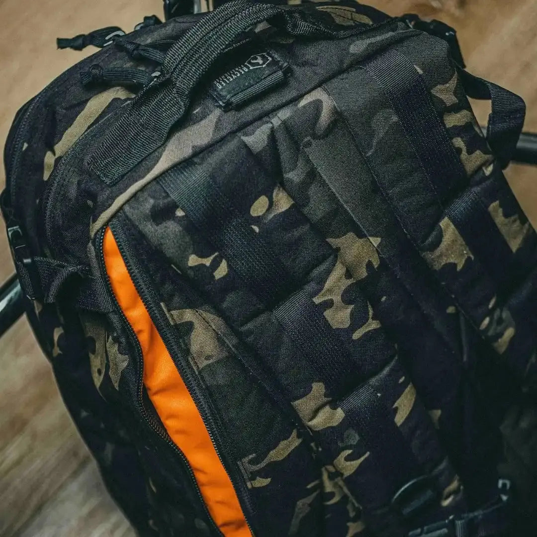 12 Hour Plus Backpack with camouflage pattern and orange interior