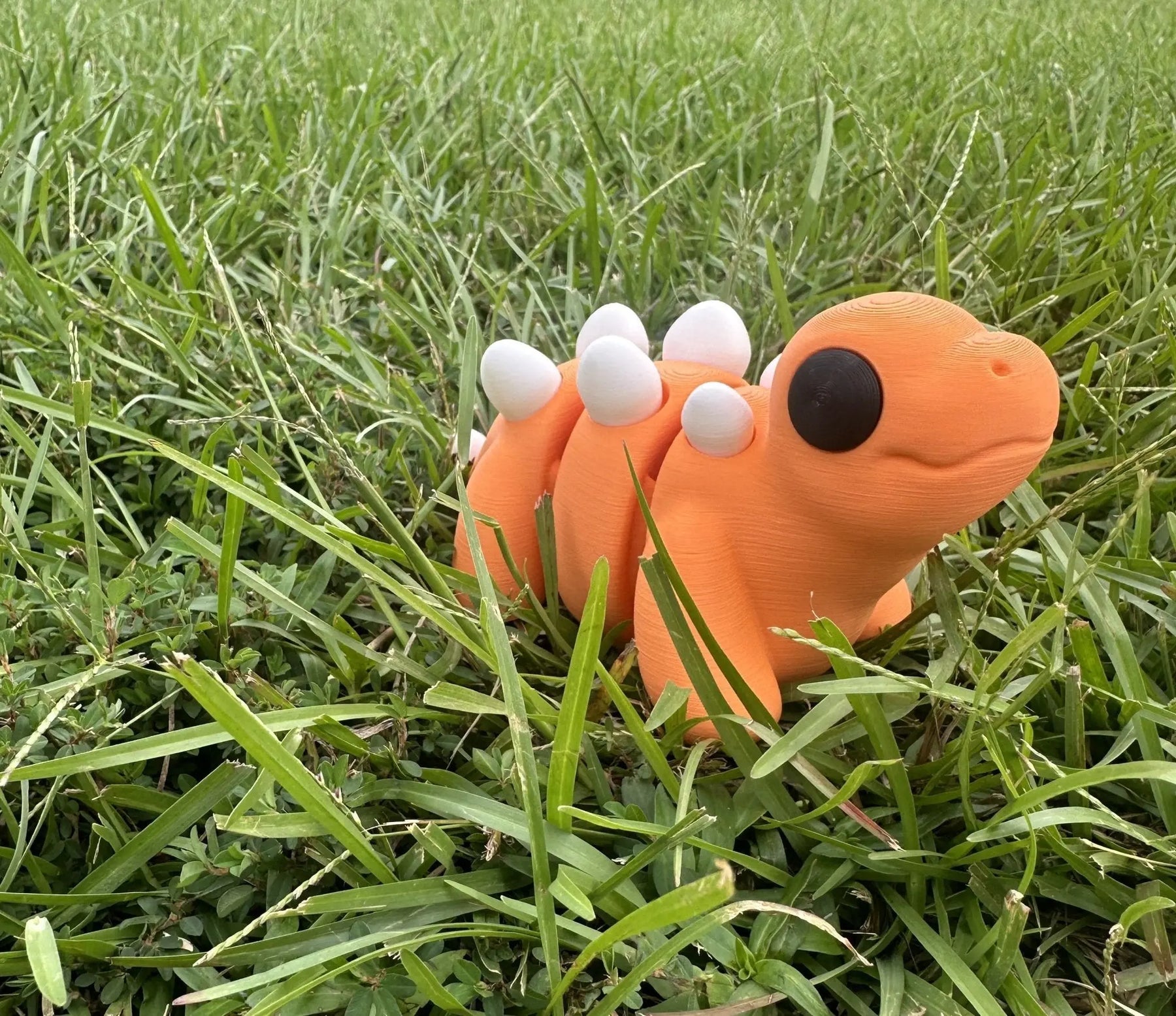 3D Printed Stegosaurus Toy - Orange Fidget Toy handmade by Main Street Collective