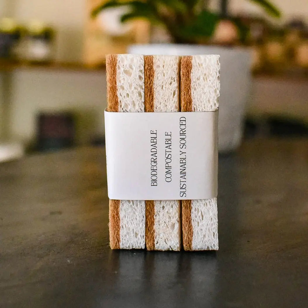 Set of 3 natural sponges with alternating white cellulose and brown coconut fiber strips.
