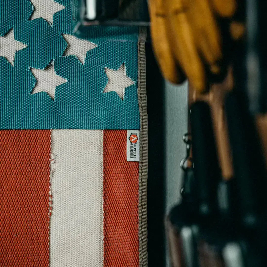 American flag made from recycled fire hose with white stars and red and white stripes.
