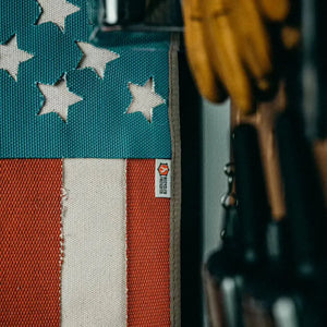 American flag made from recycled fire hose with white stars and red and white stripes.