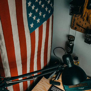 American flag made from red, white, and blue fire hose with canvas backing.