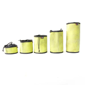 Five yellow recycled fire hose gear bags in ascending sizes.