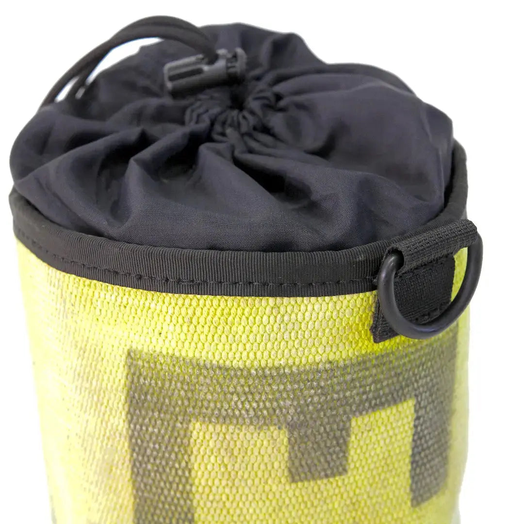 Close-up of a yellow ammo and gear bag with a black drawstring closure and D-ring.