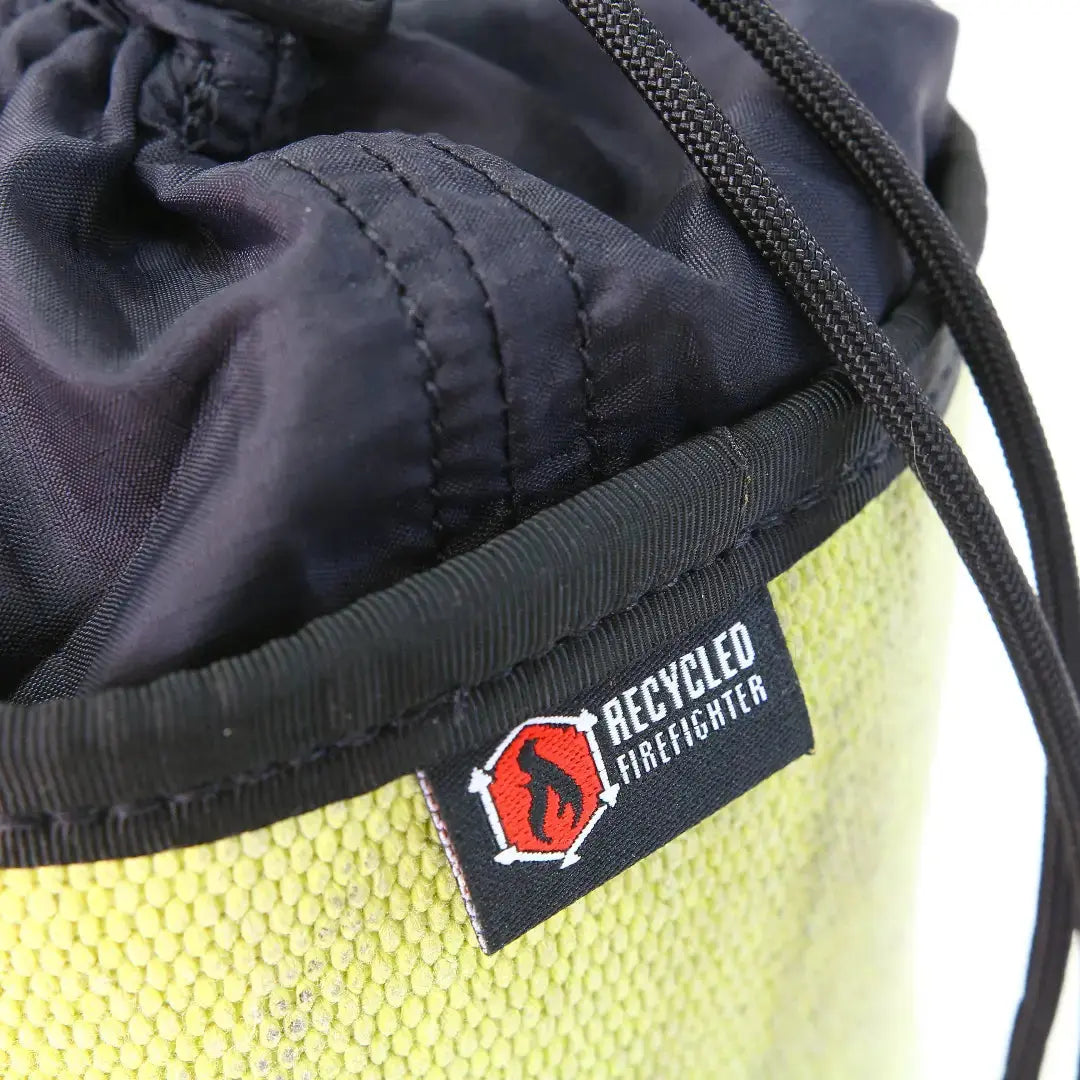 Black and yellow ammo gear bag made from recycled firefighter hose with a Recycled Firefighter label.