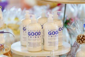 Multiple bottles of Arni-cover-y Arnica + Mint Hand & Body Lotion with pump dispensers.