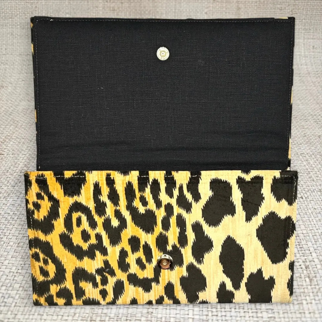 Open ASHLEY CLUTCH with leopard print exterior and black linen interior