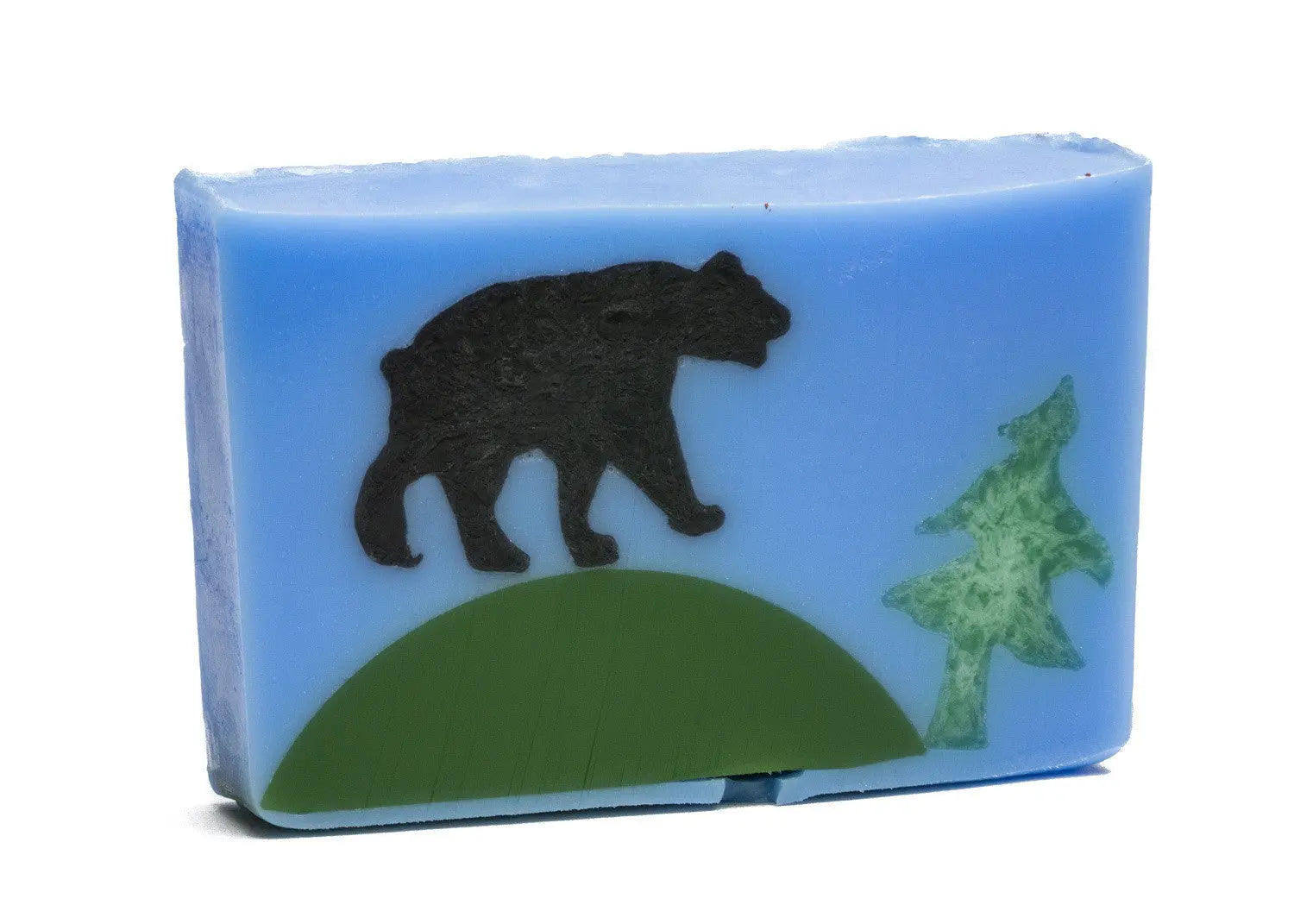 Blue soap slice with a black bear silhouette, green hill, and green tree design.