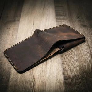 Brown leather bifold wallet with contrast stitching and embossed logo.