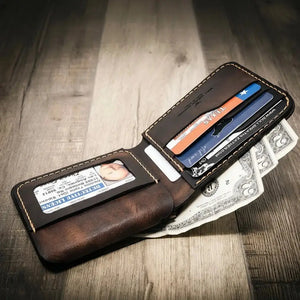 Brown leather bifold wallet with Texas ID, credit cards, and cash on wood