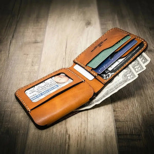 Brown leather bifold wallet with ID window, card slots, and cash.