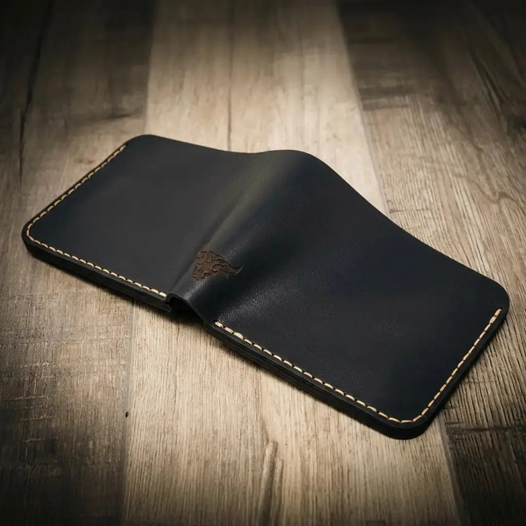 Dark blue leather bifold wallet with embossed bull logo and white stitching.