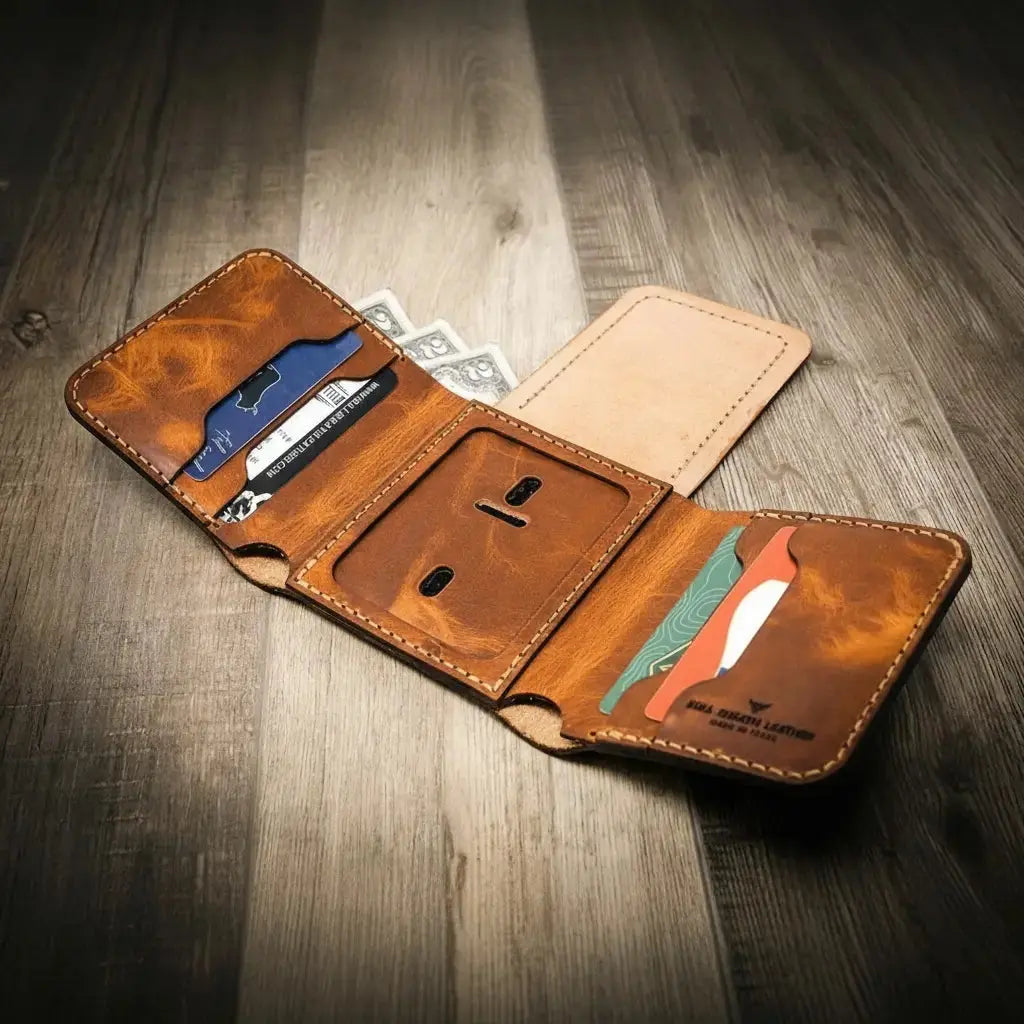 Brown leather trifold wallet open, showing card slots, cash pocket, and ID badge window.