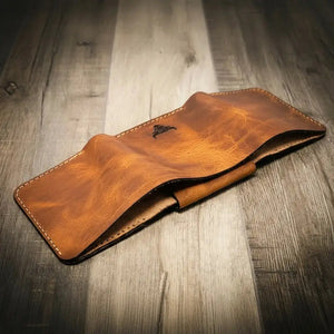 Brown leather trifold badge wallet with embossed bull logo.