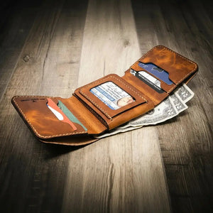 Brown leather trifold wallet open with cards and US dollar bills