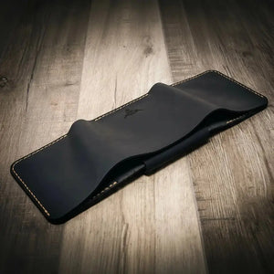 Dark blue leather trifold wallet with embossed logo and contrasting stitching.