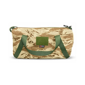 Camouflage barrel duffle bag with green straps and a patch.