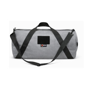 Gray 1000D Cordura barrel duffle bag with black straps and patch.