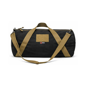Black 1000D Cordura barrel duffle bag with tan straps and patch