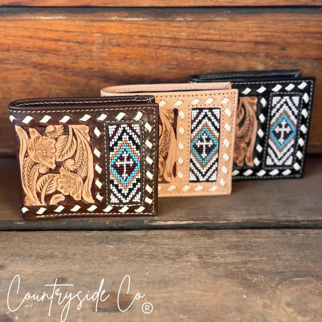 Three leather men's wallets with beaded cross designs and floral tooling.