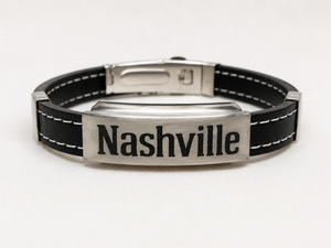 Black leather bracelet with silver clasp and 'Nashville' engraving on a white background