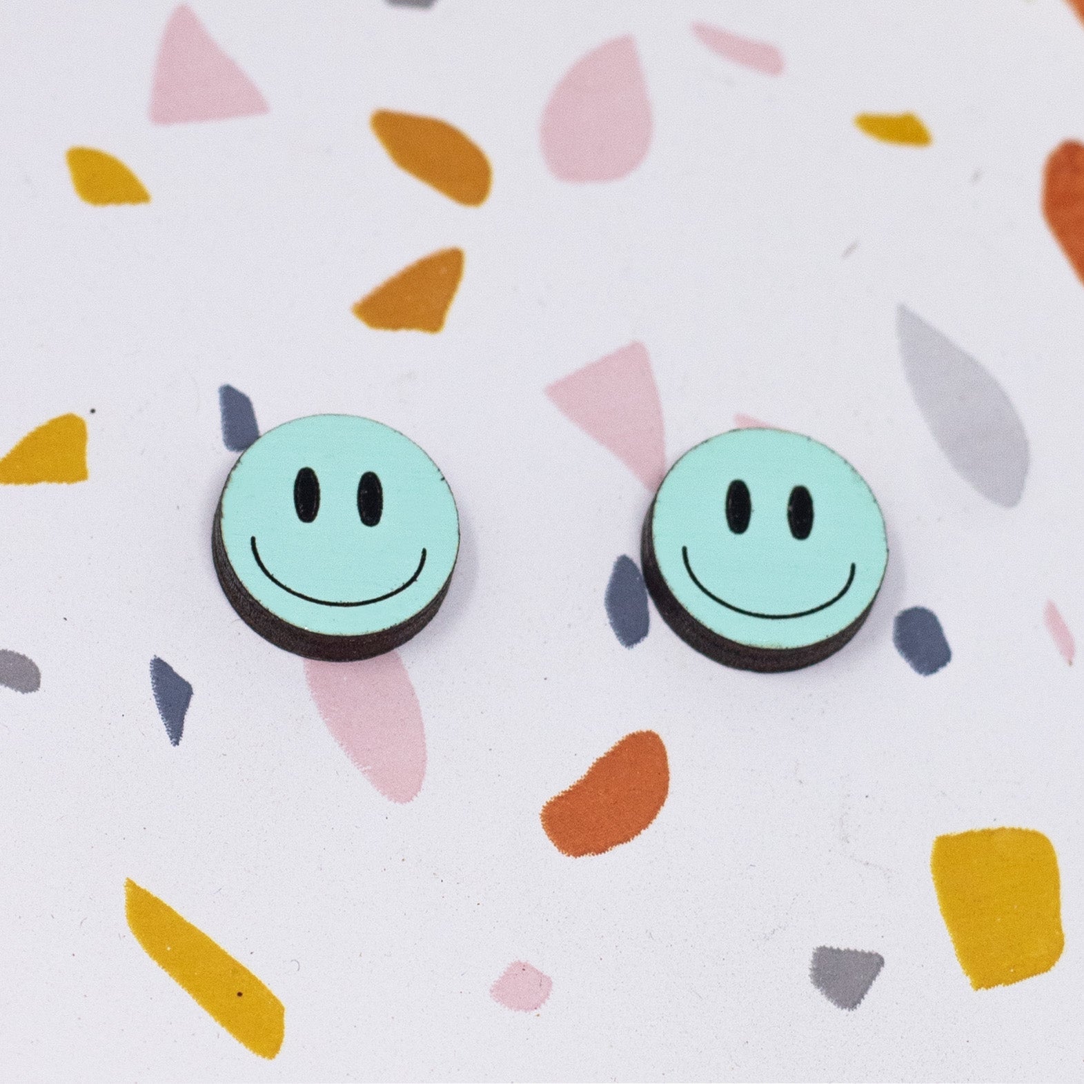 Additional view of Happy Face Stud Earrings, 3 Colors Available hand painted on lightweight wood by LE CHIC MIAMI