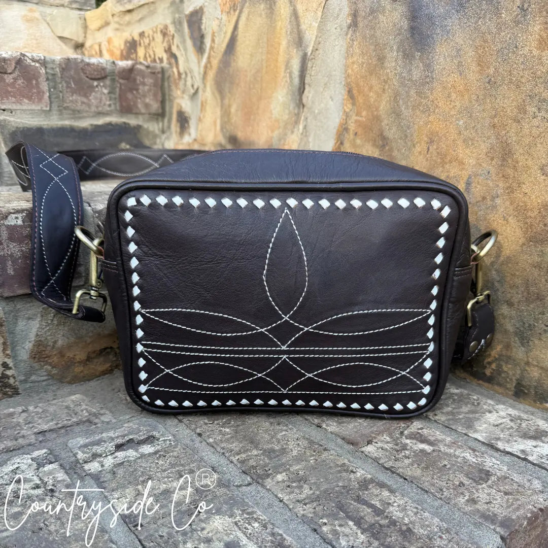 Brown genuine leather crossbody purse with white boot stitch design.