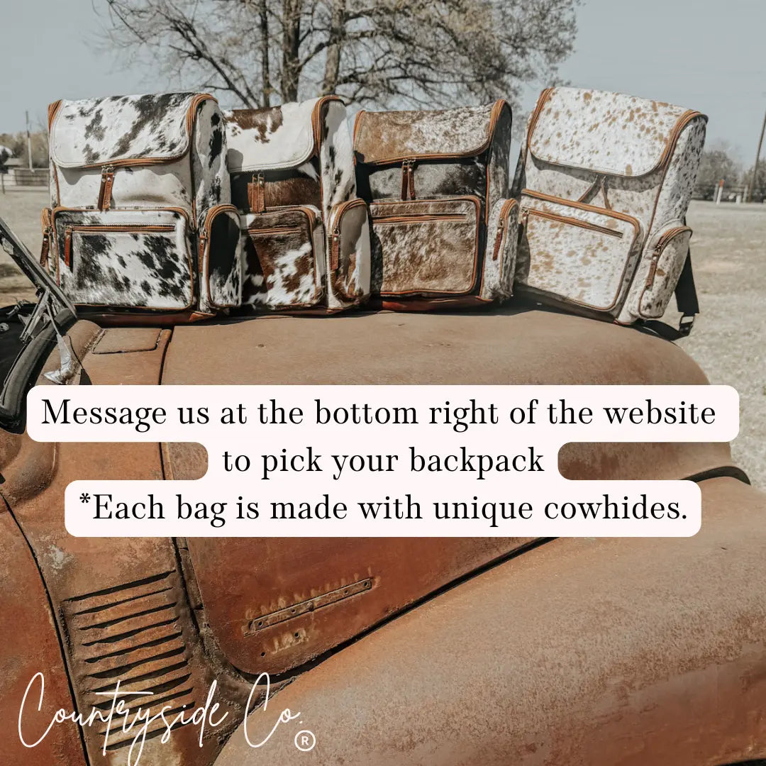 Cowhide backpacks on a vintage truck with 'Countryside Co.' logo.
