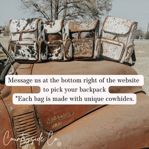Cowhide backpacks on a vintage truck with 'Countryside Co.' logo.