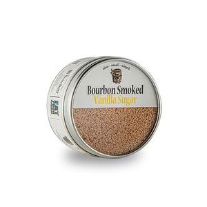 Bourbon Smoked Vanilla Sugar in a round tin with a clear lid.