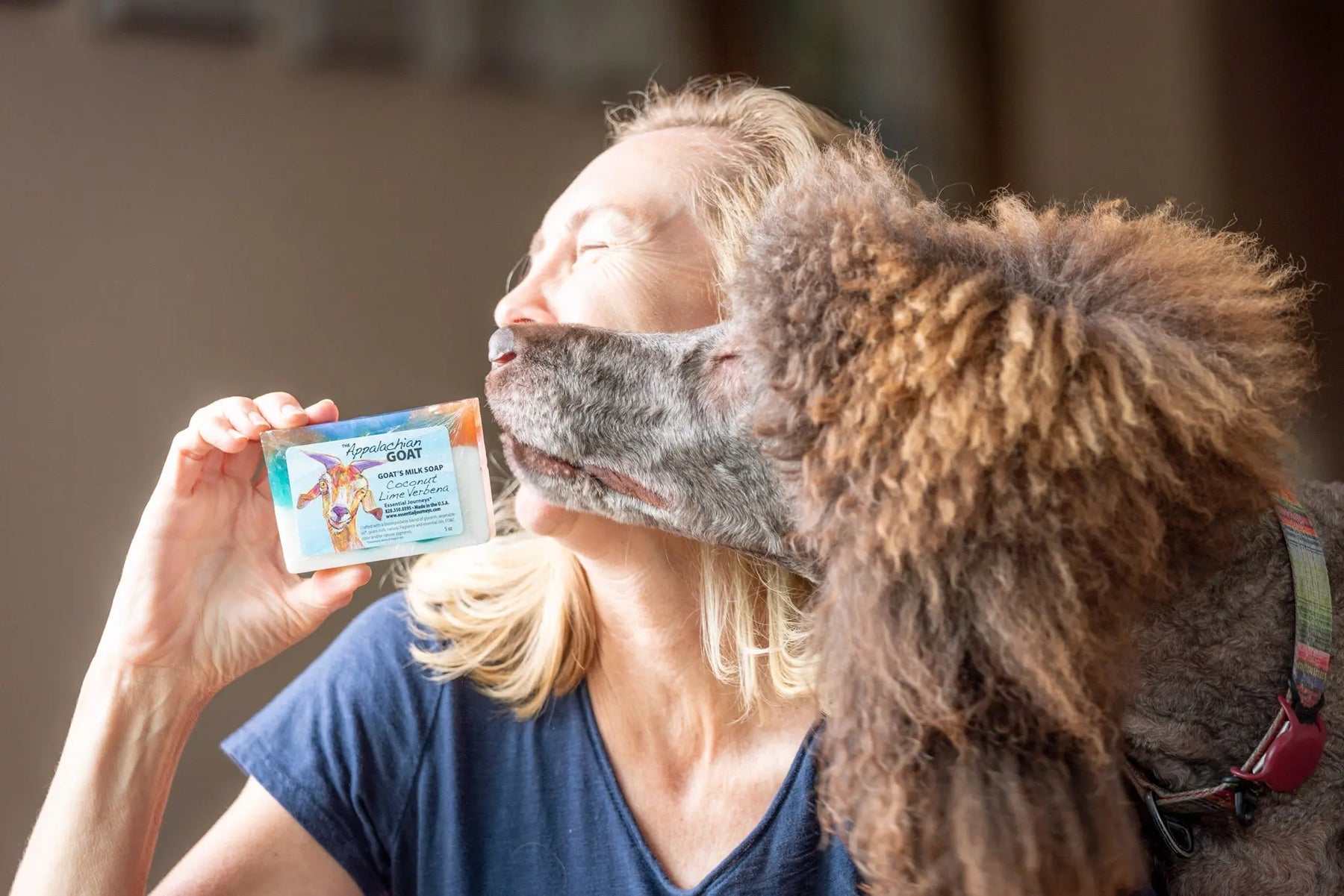 Woman holding Appalachian Goat coconut lime verbena goat milk soap slice.