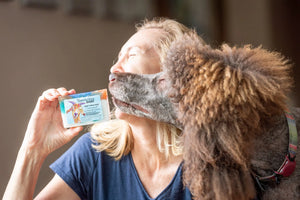 Woman holding Appalachian Goat coconut lime verbena goat milk soap slice.