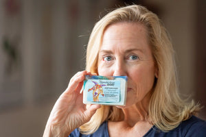Woman holding Appalachian Goat Coconut Lime Verbena goat milk soap.