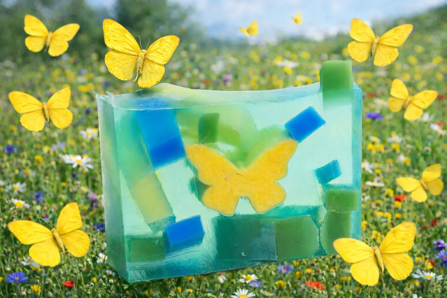 Clear soap with yellow butterfly and blue and green inserts with yellow butterflies flying in a field.