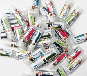 Pile of Appalachian Goat lip balm tubes in Coconut Milk and other flavors.