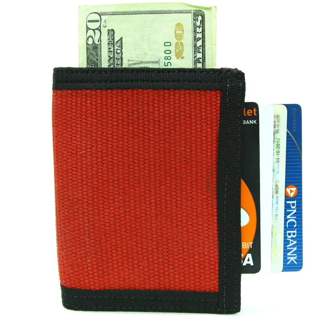 Red canvas bifold wallet with money and credit cards, including a PNC Bank card.