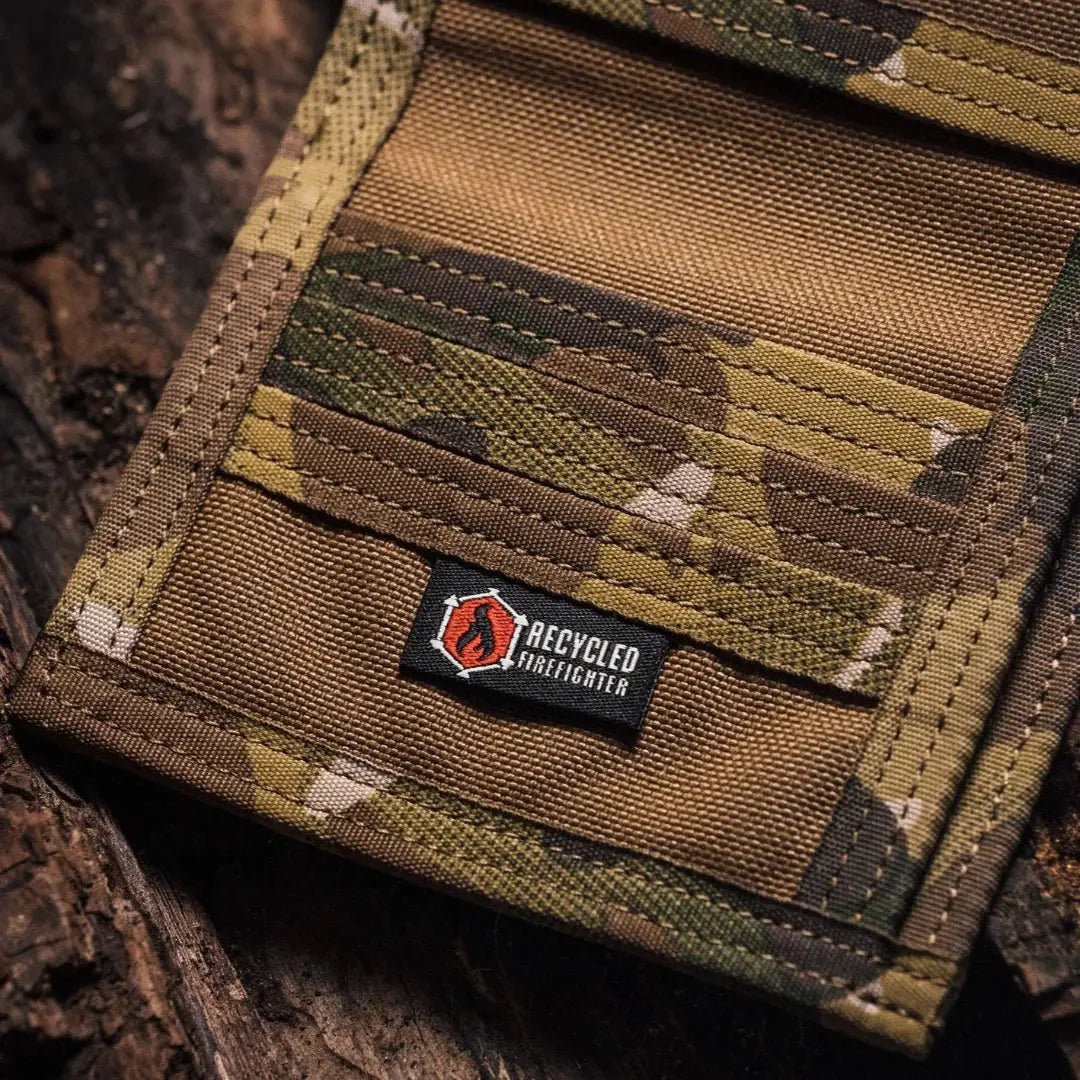 Bifold wallet made from multi-cam camouflage fire hose material with Recycled Firefighter logo.