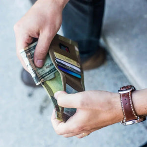 Person handling money and cards in a Captain Wallet Hypalon Edition.