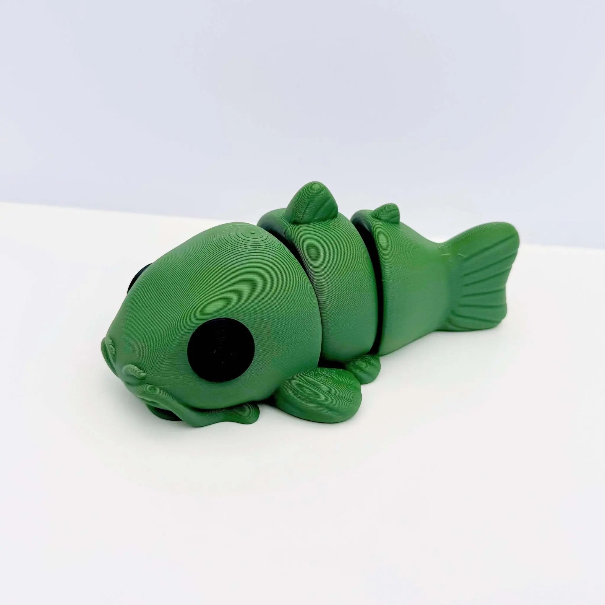 Green 3D printed catfish fidget toy. Sensory & stress relief for kids and adults. Toy catfish with joints.