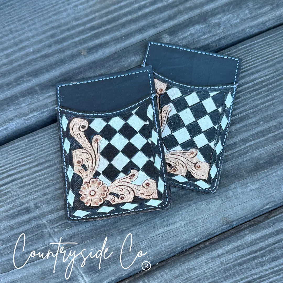 Black and white checkerboard tooled leather credit card holder with floral design.