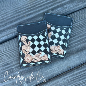 Black and white checkerboard tooled leather credit card holder with floral design.