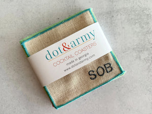 Set of 8 burlap cocktail coasters with colorful stitched edges and "SOB" embroidered.