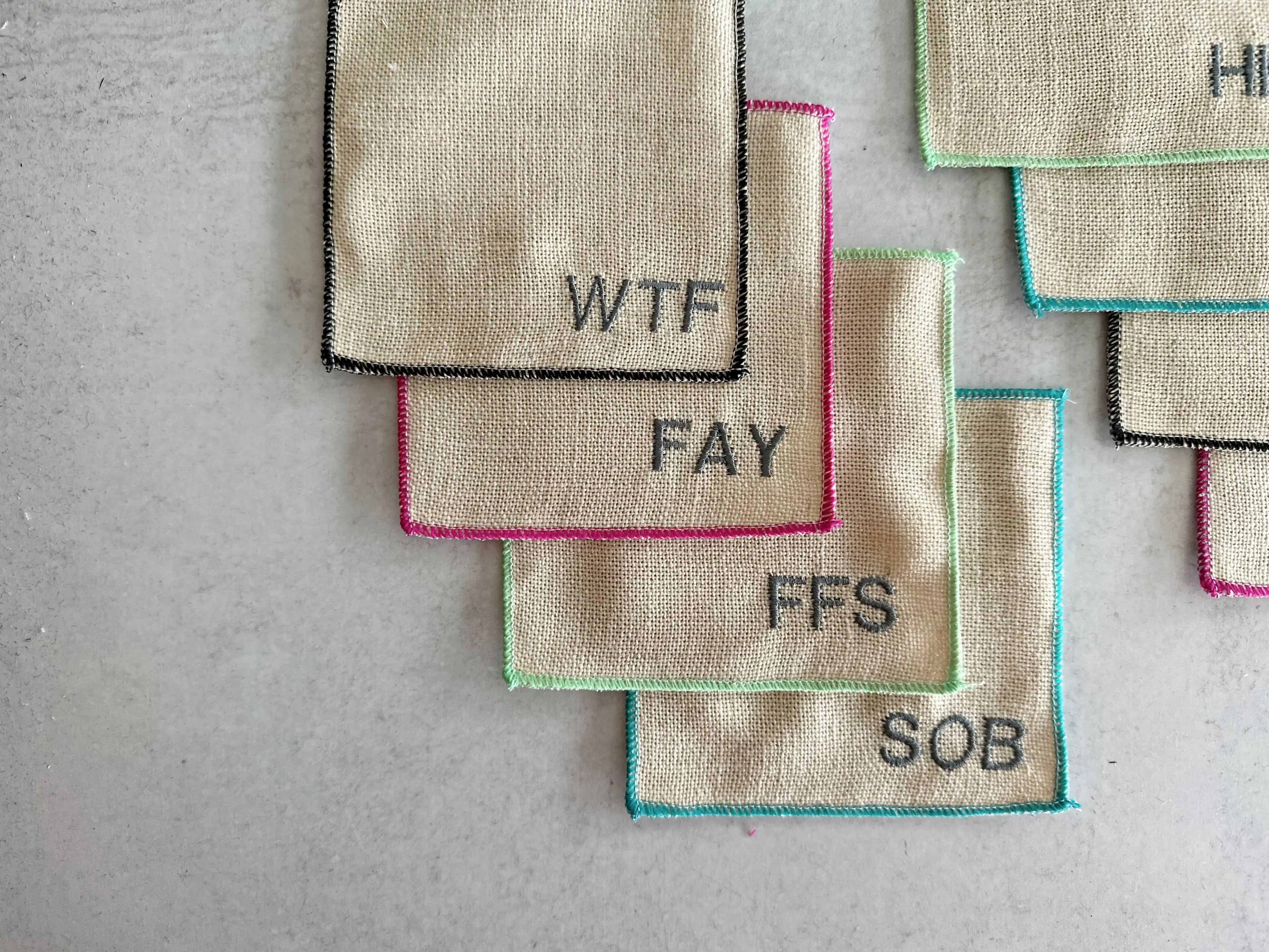 Linen coasters with embroidered letters: WTF, FAY, FFS, SOB, HI, and more