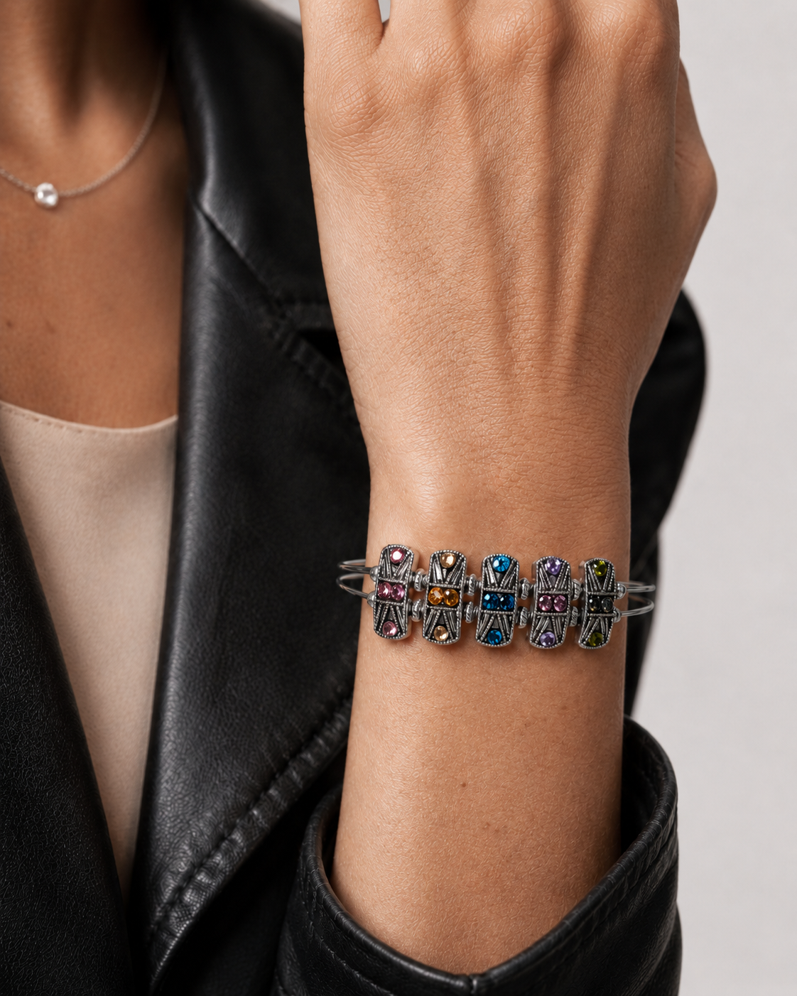 Rainbow rhinestone bracelet worn with black jacket