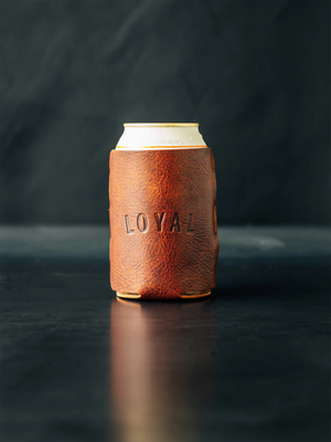Brown leather coozie with the word "LOYAL" on a can, featuring the Loyal Stricklin logo at the bottom, suitable for a 12oz can.