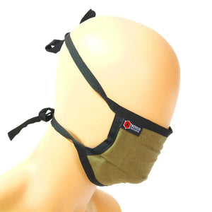 Khaki cotton face mask with black trim and tie-back closure on a mannequin.